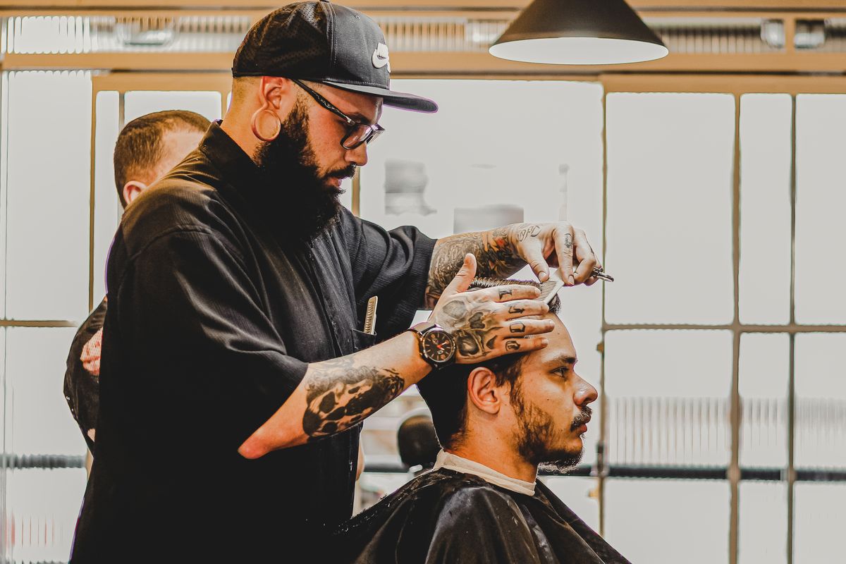 Barber cutting a client's hair in a barbershop